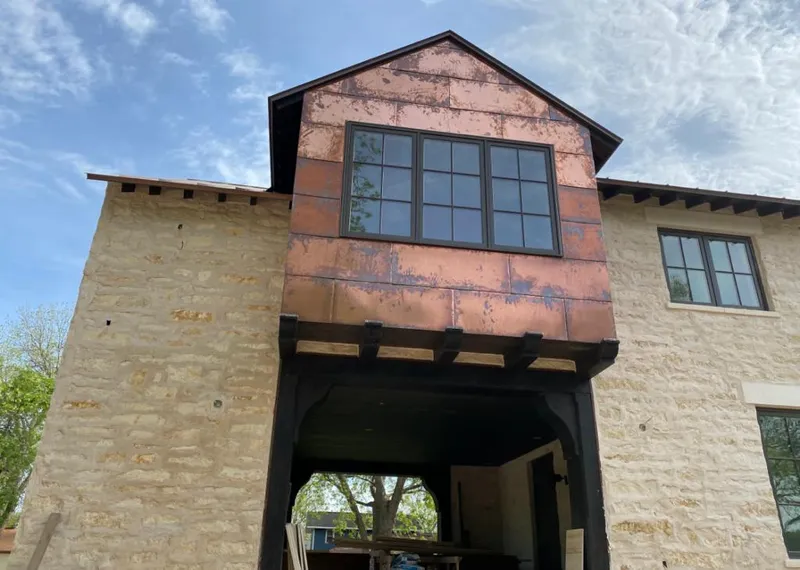 Copper metal panel facade on a stone building for Skylight Installation in Grand Terrace